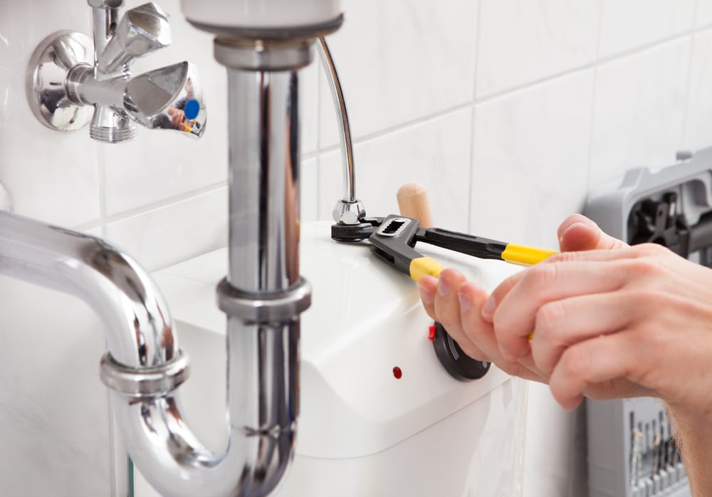 Portrait,Of,Male,Plumber,Fixing,A,Sink,In,Bathroom plumbing service water heater